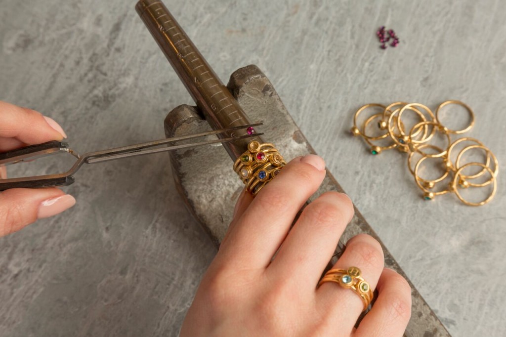 person making ring by hand with tools